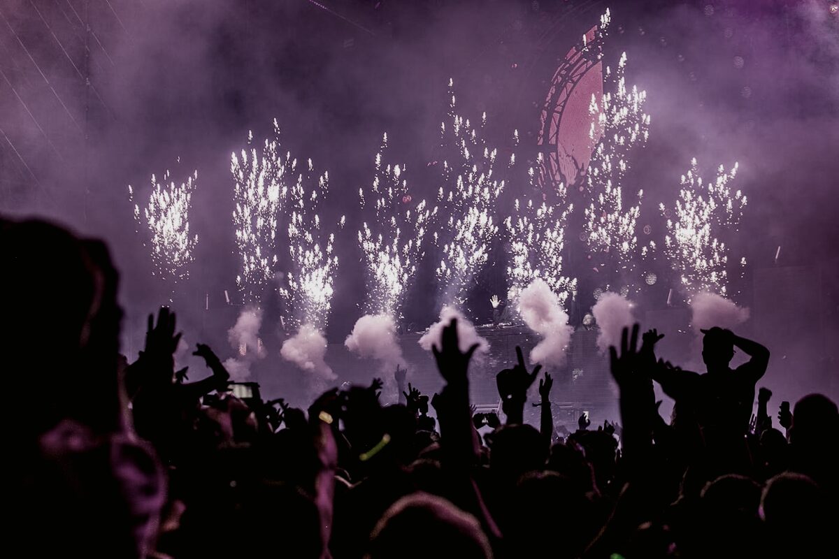 A large festival crowd at an outdoor concert
