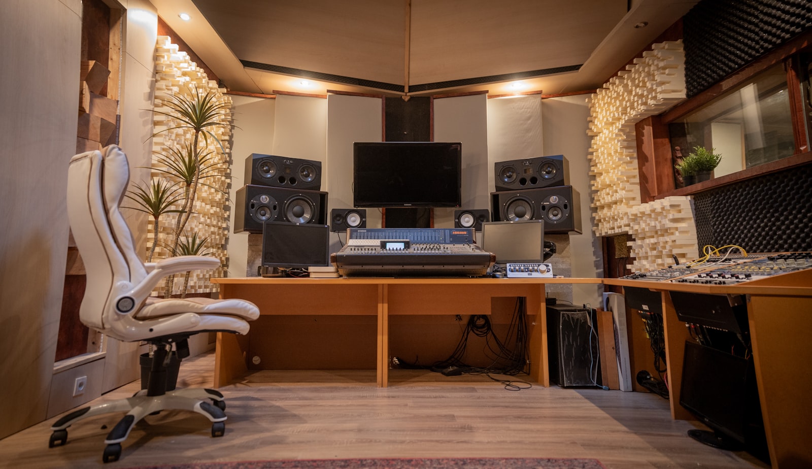 A professional recording studio control room with an analog mixing console